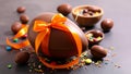 Chocolate Easter egg with orange ribbon and candies on a dark surface Royalty Free Stock Photo