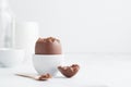 Chocolate easter egg in a white eggholder Royalty Free Stock Photo