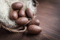 Chocolate Easter eggs in a basket on wooden background Royalty Free Stock Photo