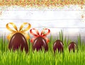 Chocolate Easter eggs with bows on white rustic wooden background with colorful sugar powder or confetti