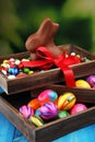 Chocolate Easter eggs and chocolate bunny and colorful sweets. Royalty Free Stock Photo