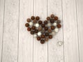 Chocolate Easter eggs heart on white wooden floor - top view Royalty Free Stock Photo