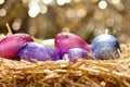 Chocolate Easter eggs in a natural straw nest