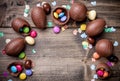 Chocolate easter eggs and sweets on wooden background