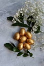 Chocolate Easter Eggs Wrapped in Gold Foil. Easter postcard Royalty Free Stock Photo