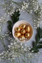 Chocolate Easter Eggs Wrapped in Gold Foil. Easter postcard Royalty Free Stock Photo