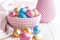 Chocolate easter eggs wrapped in multi colored foil in bowl on white table Royalty Free Stock Photo
