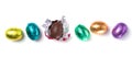 Chocolate easter eggs wrapped in multi colored foil isolated on white background