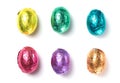 Chocolate easter eggs wrapped in multi colored foil isolated on white background Royalty Free Stock Photo