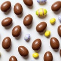 Chocolate Easter eggs and yellow rubber ducks on white background. Top view. Royalty Free Stock Photo