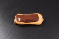 Chocolate eclair on black background. Eclairs with glaze. Royalty Free Stock Photo
