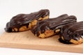 Chocolate eclair on wooden desk food photography. Bekery, cake , choco, pie, confectionary, cream. Three fresh eclairs with chocol