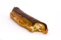 Chocolate eclaire with a bite taken Royalty Free Stock Photo