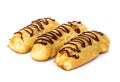 Chocolate eclairs with cream filling on a platter isolated