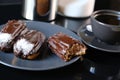 Chocolate eclairs on a plate and cup of coffee. traditional fcench Chocolate Eclairs