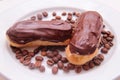 Chocolate eclairs on plate on white background