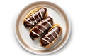 Chocolate Eclairs On Plate, White Background. Generative AI Royalty Free Stock Photo