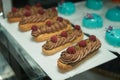 Chocolate eclairs with raspberry. Traditional Cream eclairs