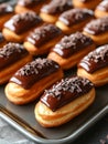 Chocolate eclairs with rich glaze on baking tray. Royalty Free Stock Photo