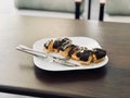 Chocolate Eclairs Served with Plate at Restaurant.