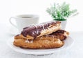 Chocolate eclairs on white plate Royalty Free Stock Photo