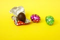 Chocolate egg in colorful foil for Easter on a pink background. The egg is wrapped in red foil. Happy Easter. Chocolate Royalty Free Stock Photo