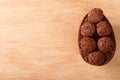 Chocolate egg with filling for Easter on wooden background