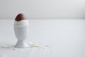 Chocolate egg on white eggstand holder Royalty Free Stock Photo