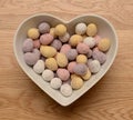 Chocolate eggs heart shaped bowl Royalty Free Stock Photo