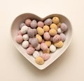 Chocolate eggs heart shaped bowl Royalty Free Stock Photo