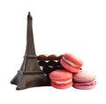 Chocolate Eiffel Tower, three macarons and broken milk and dark chocolate bars on white background