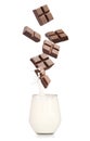 Chocolate falling into glass with milk on white background Royalty Free Stock Photo