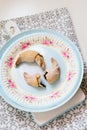 Chocolate filled crescent rolls (croissants) with ice sugar topping arranged on plate and cutting board