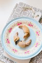 Chocolate filled crescent rolls (croissants) with ice sugar topping arranged on plate and cutting board