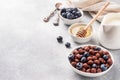 Chocolate flakes made from natural cereals with fresh blueberries, honey and milk. The concept of a healthy wholesome Breakfast. Royalty Free Stock Photo