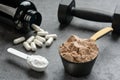 Chocolate flavored protein, creatine and amino acid capsules close-up. The concept of sports supplements