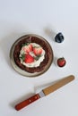 Chocolate flourless cake with strawberries, blueberries and whipping cream. Royalty Free Stock Photo