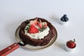 Chocolate flourless cake with strawberries, blueberries and whipping cream. Royalty Free Stock Photo