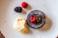 Chocolate fondant cupcake with raspberries, ice creme and powdered sugar placed on plate Royalty Free Stock Photo