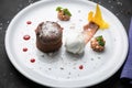 Chocolate fondant with ice cream on a white plate