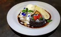 Chocolate fondant lava cake decorated with sprinkling of icing sugar, fresh strawberries, banana and ice cream Royalty Free Stock Photo