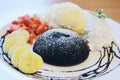 Chocolate fondant lava cake decorated with strawberries and vanilla ice cream Royalty Free Stock Photo