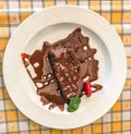 Chocolate fondant with mint on plate, closeup.