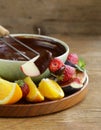 Chocolate fondue with various fruits - delicious dessert Royalty Free Stock Photo