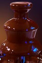 Chocolate fountain fondue. Chocolate fountain on a dark gradient background Royalty Free Stock Photo