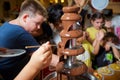 Chocolate fountain with fruits. Children birthday party . Homemade chocolate fountain fondue with marshmallow on a skewer dripping