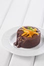 Chocolate fountain, orange cupcake. Photo of food on a white background