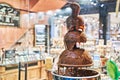 Chocolate fountain in store showcase. Brussels, Belgium. Royalty Free Stock Photo