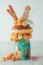 Chocolate freak shake topping with donut and popcorn with sweets