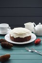 Chocolate fruit cake with cream cheese and black tea decorated with cones on dark background Royalty Free Stock Photo